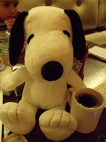 Snoopy enjoying a cup of coffee at Ghost Town Grill