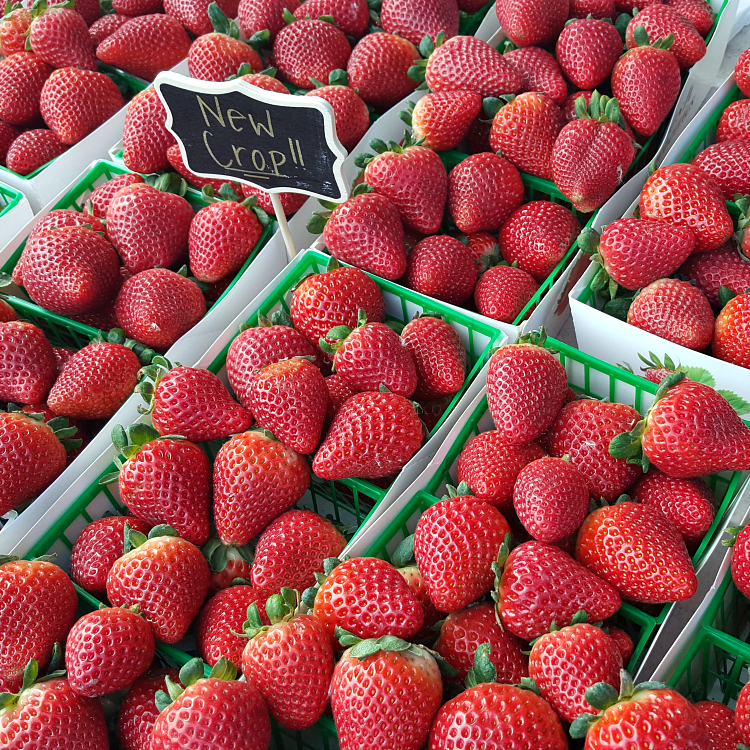 baskets of fresh strawberries at a farmers market