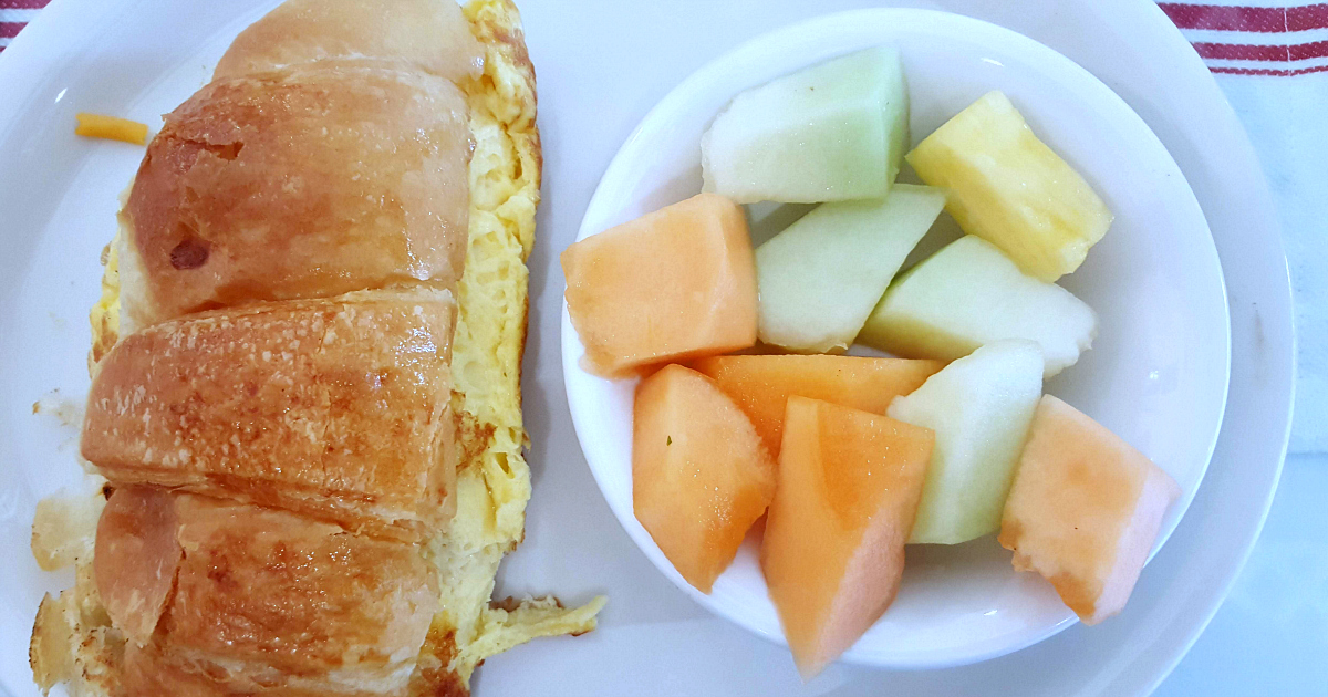 crossanwich egg sandwich and fruit bowl