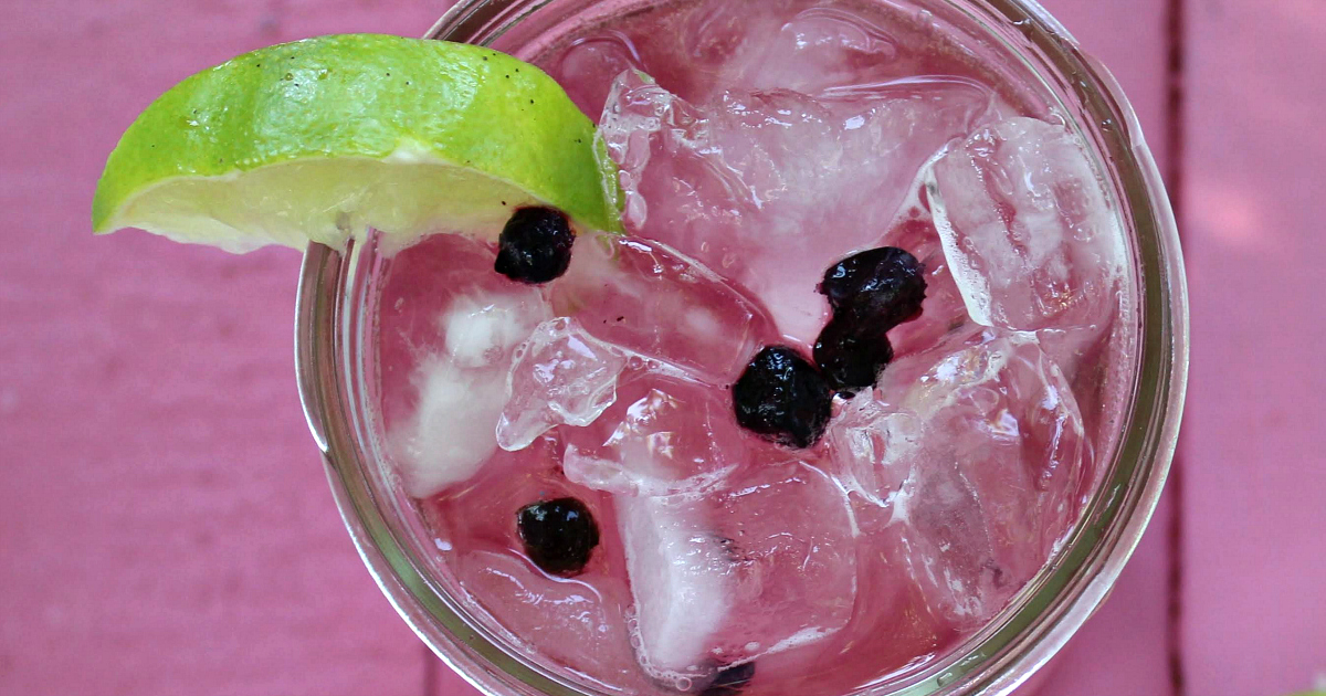 close up overhead view blueberry lime soda in mason jar