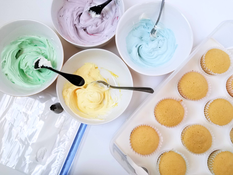 colored frosting and supplies for unicorn cupcakes