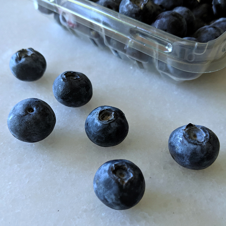 insta blueberries on white marble