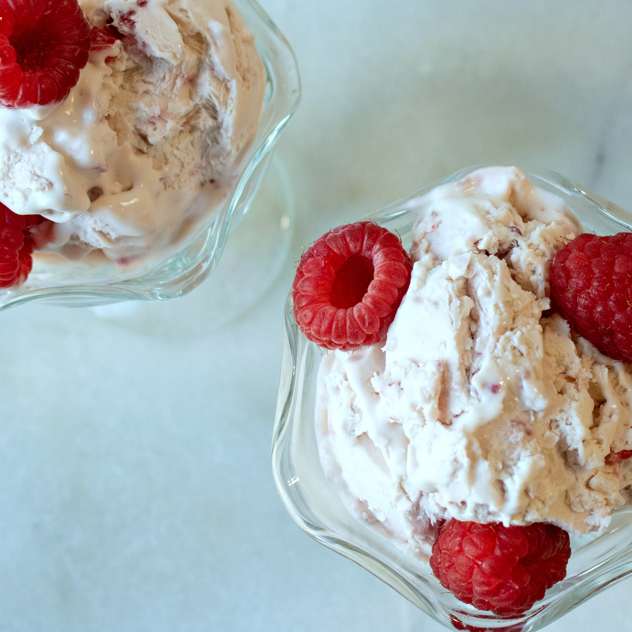 overhead image of two bowls of raspberry cheesecake ice cream