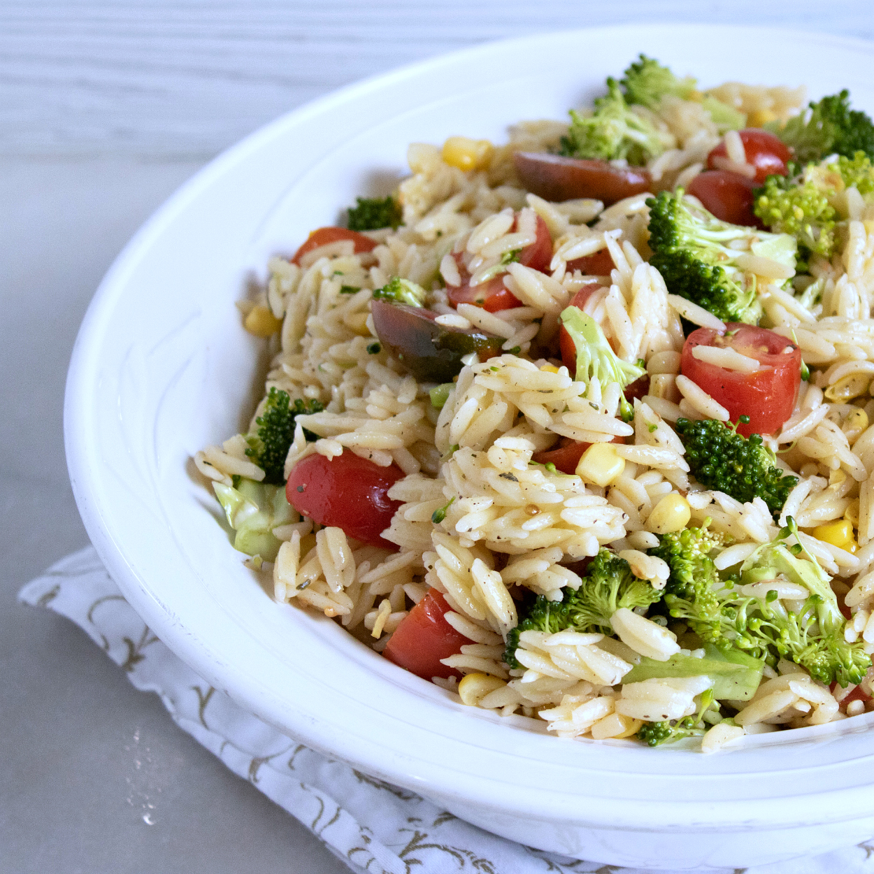 orzo pasta salad in white bowl