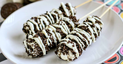 three cookies and cream marshmallow pops on white plate