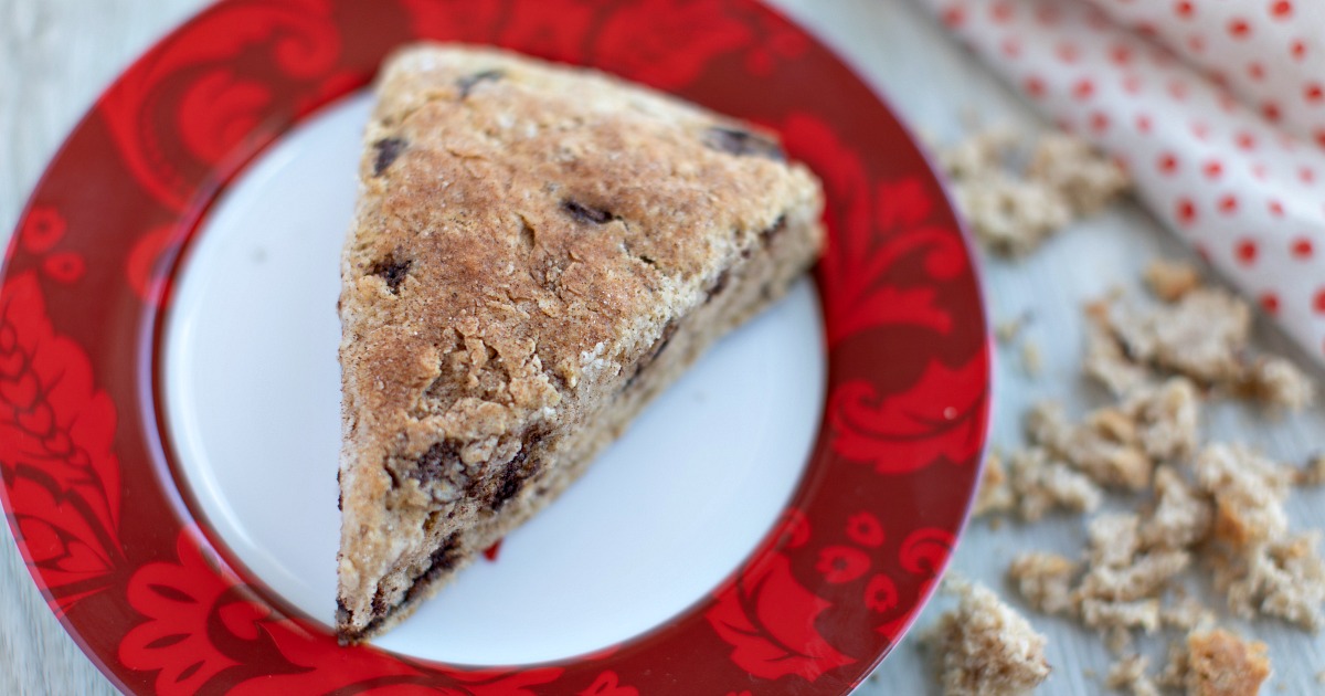 cinnamon scone on white plate with red edges