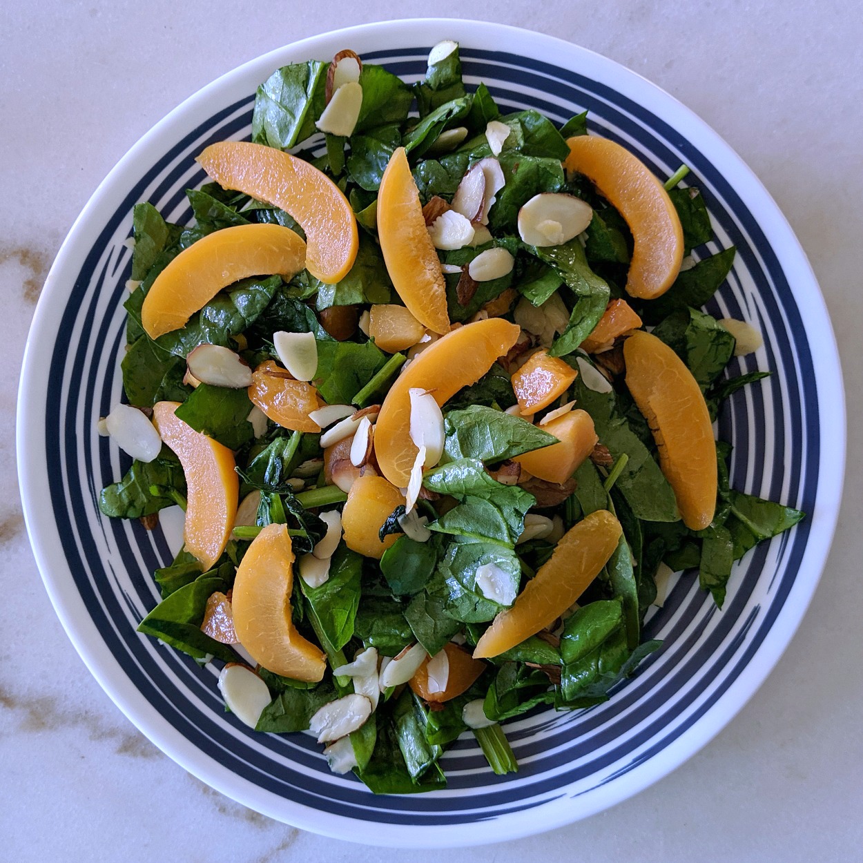 plate of apricot almond salad on white marble