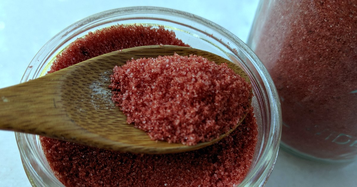 close up spoon of red peppermint sugar