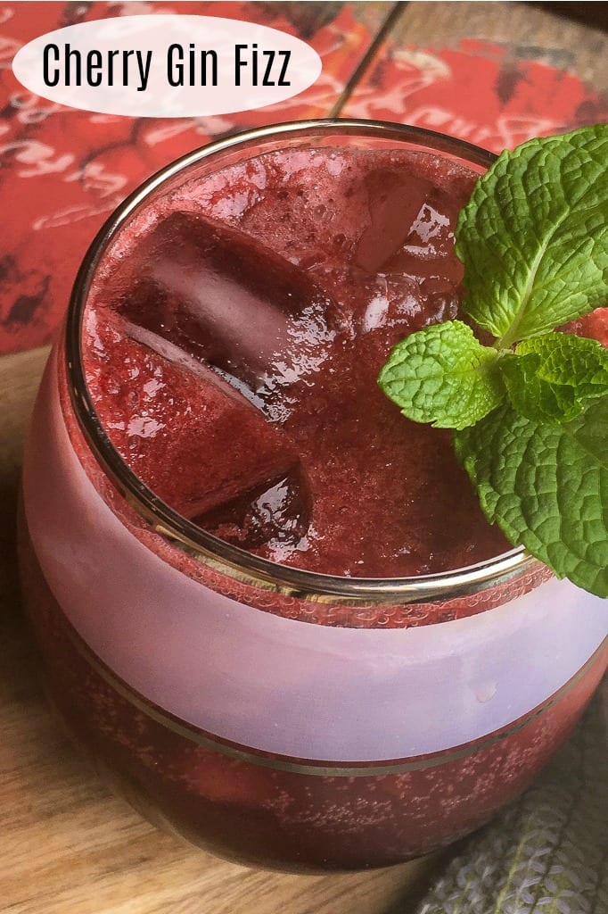 Dark Cherry Gin Fizz Cocktail with a Mint Garnish #Cocktail #GinFizz #GinCocktail #CherryCocktail