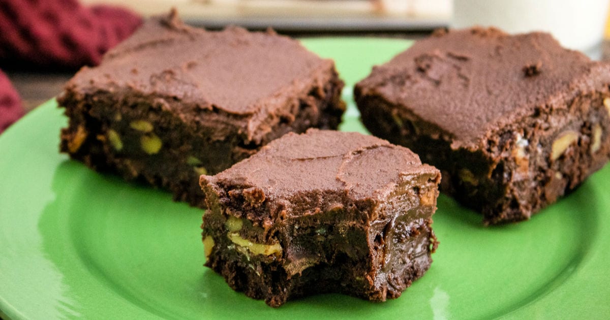 three frosted brownies with walnuts