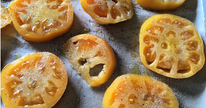 sliced yellow tomatoes on pan