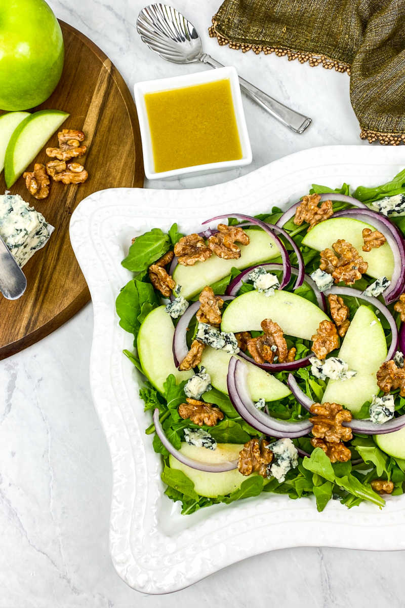 This arugula apple salad has blue cheese and honey roasted walnuts mixed in, so you will love each flavorful bite.