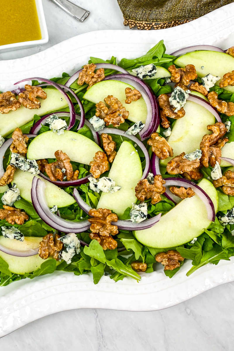 This arugula apple salad has blue cheese and honey roasted walnuts mixed in, so you will love each flavorful bite.