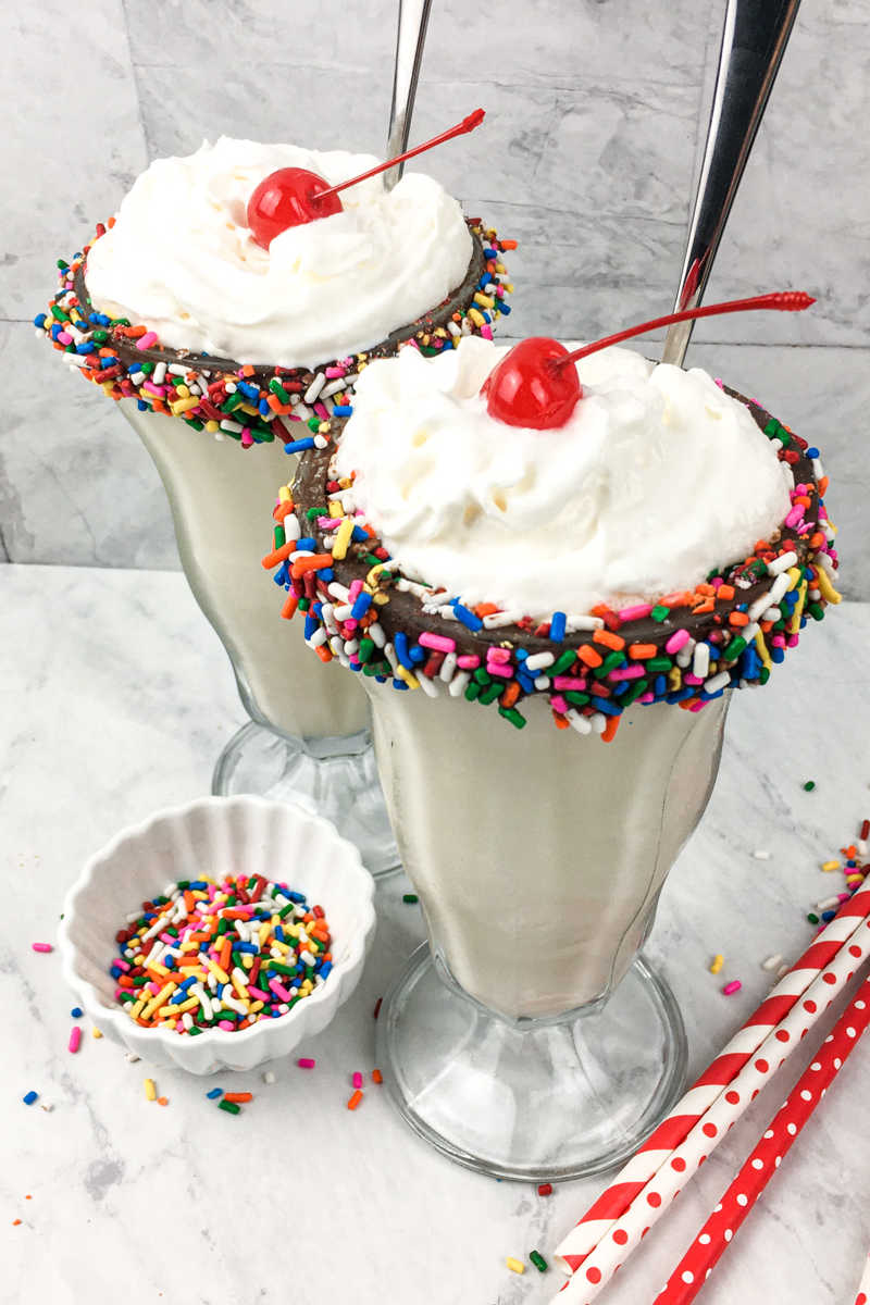 It's time to celebrate, when you make a birthday milkshake with rainbow sprinkles and a chocolate dipped soda glass.