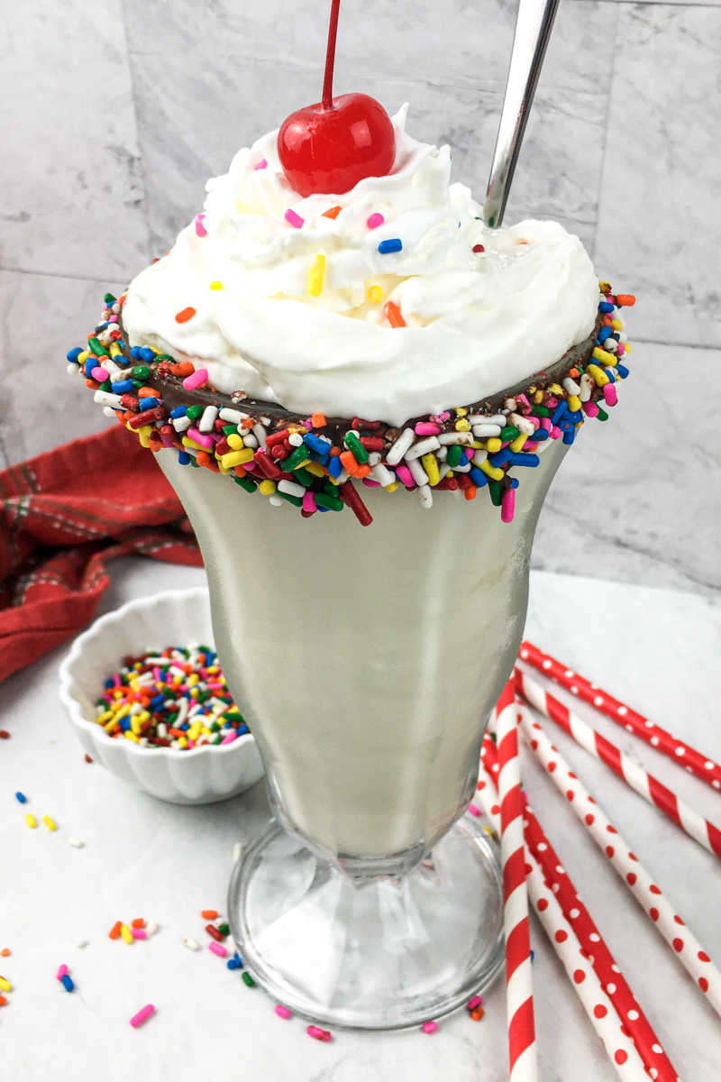 It's time to celebrate, when you make a birthday milkshake with rainbow sprinkles and a chocolate dipped soda glass.