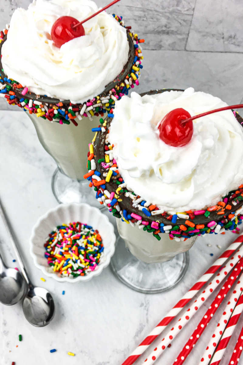 It's time to celebrate, when you make a birthday milkshake with rainbow sprinkles and a chocolate dipped soda glass.