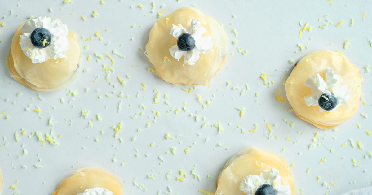 overhead view of blueberry filo stack pastries sprinkled with lemon zest.