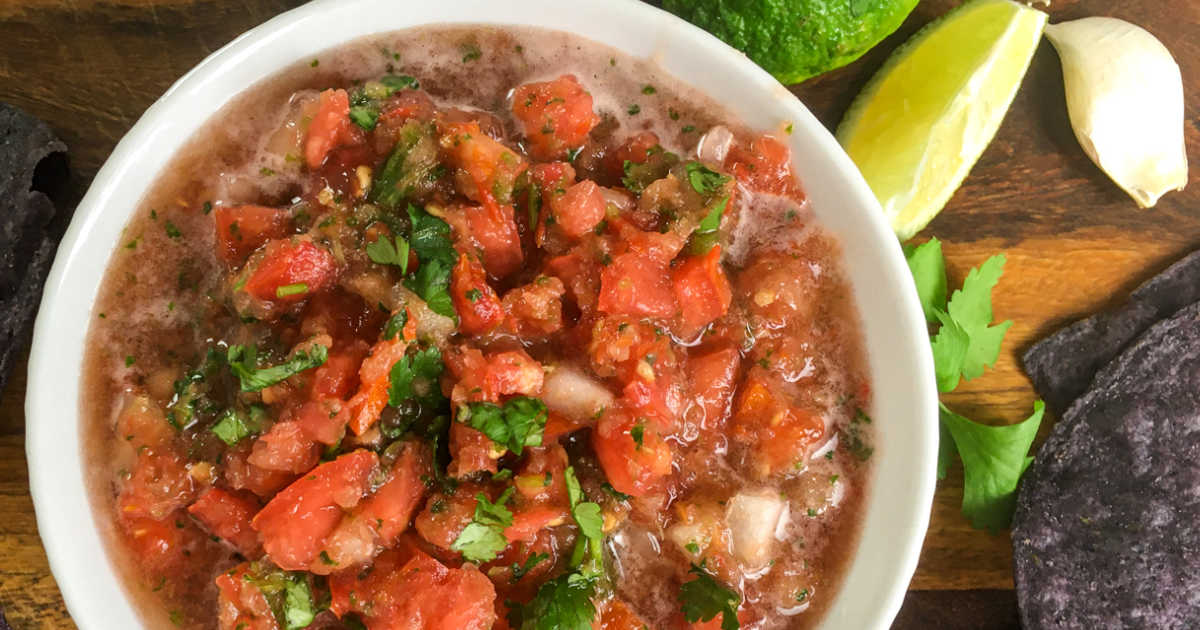 fresh homemade salsa with blue tortilla chips.