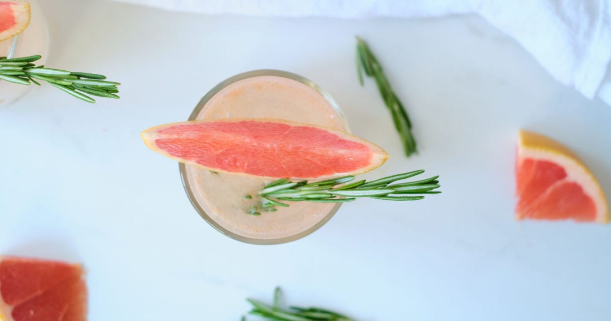 overhead view of sparkling grapefruit juice with rosemary.