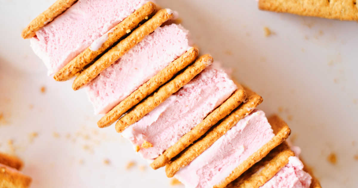 diagonal row of homemade graham cracker strawberry ice cream sandwiches.