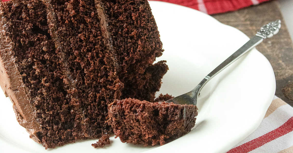 3 layer chocolate cake with fork.