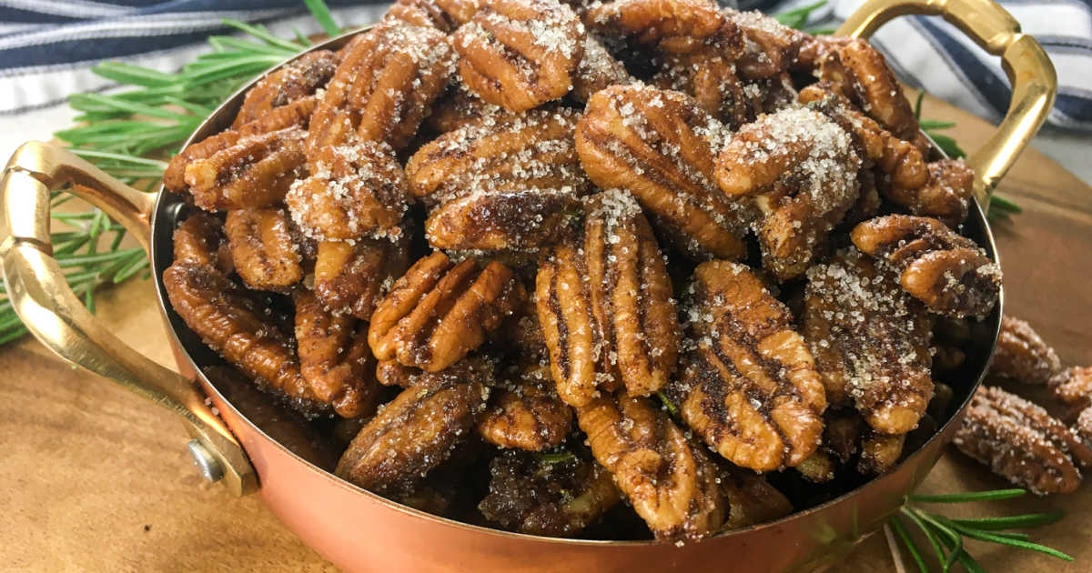 copper bowl filled with sweet maple roasted pecans.