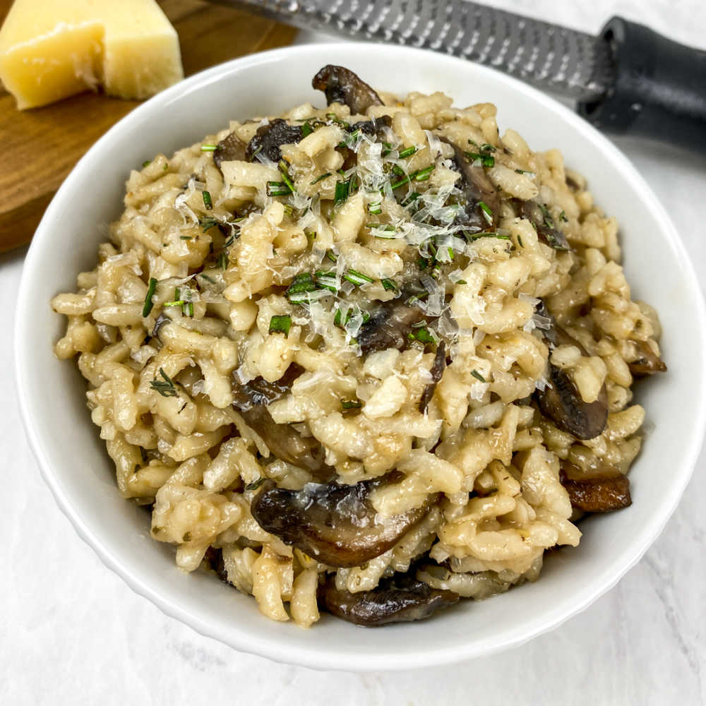 Mushroom risotto topped with parmesan and fresh rosemary.