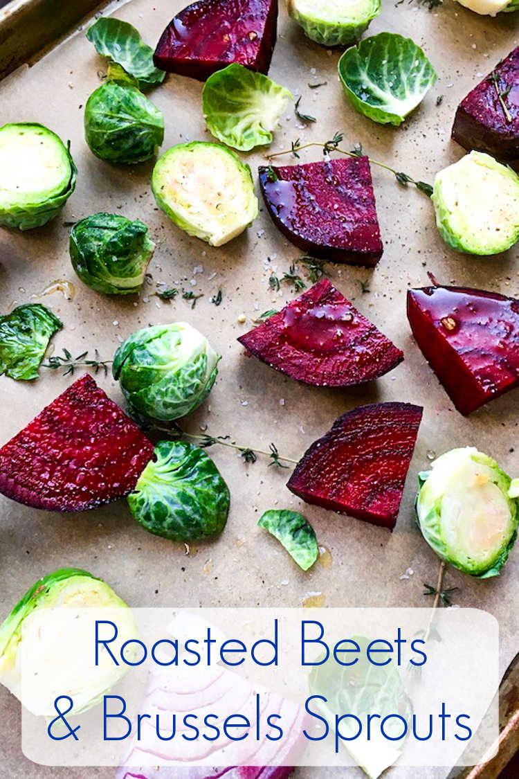 brussels sprouts and beets on parchment lined baking sheet. 