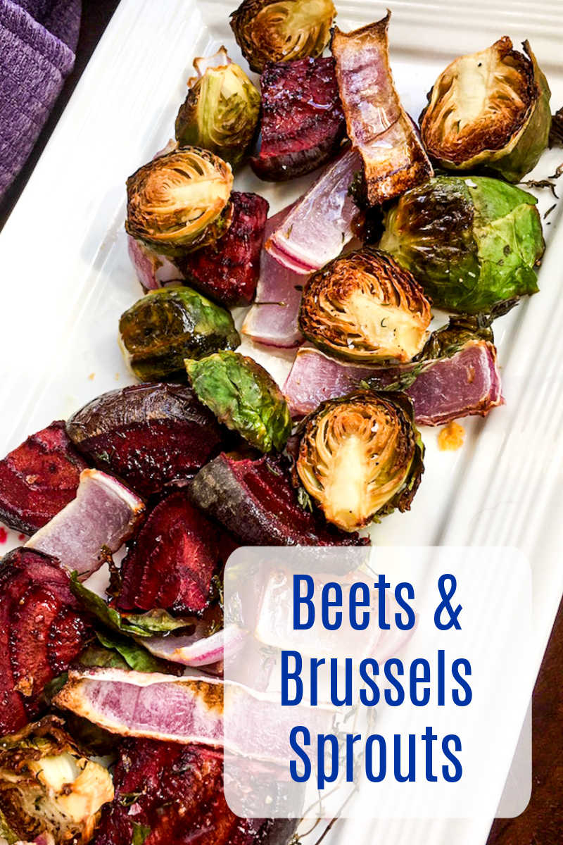 roasted beets and brussels sprouts on white serving platter.