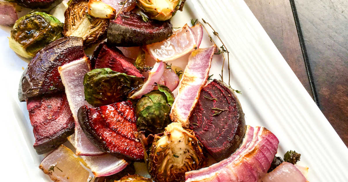 roasted beets and brussels sprouts on white serving platter.