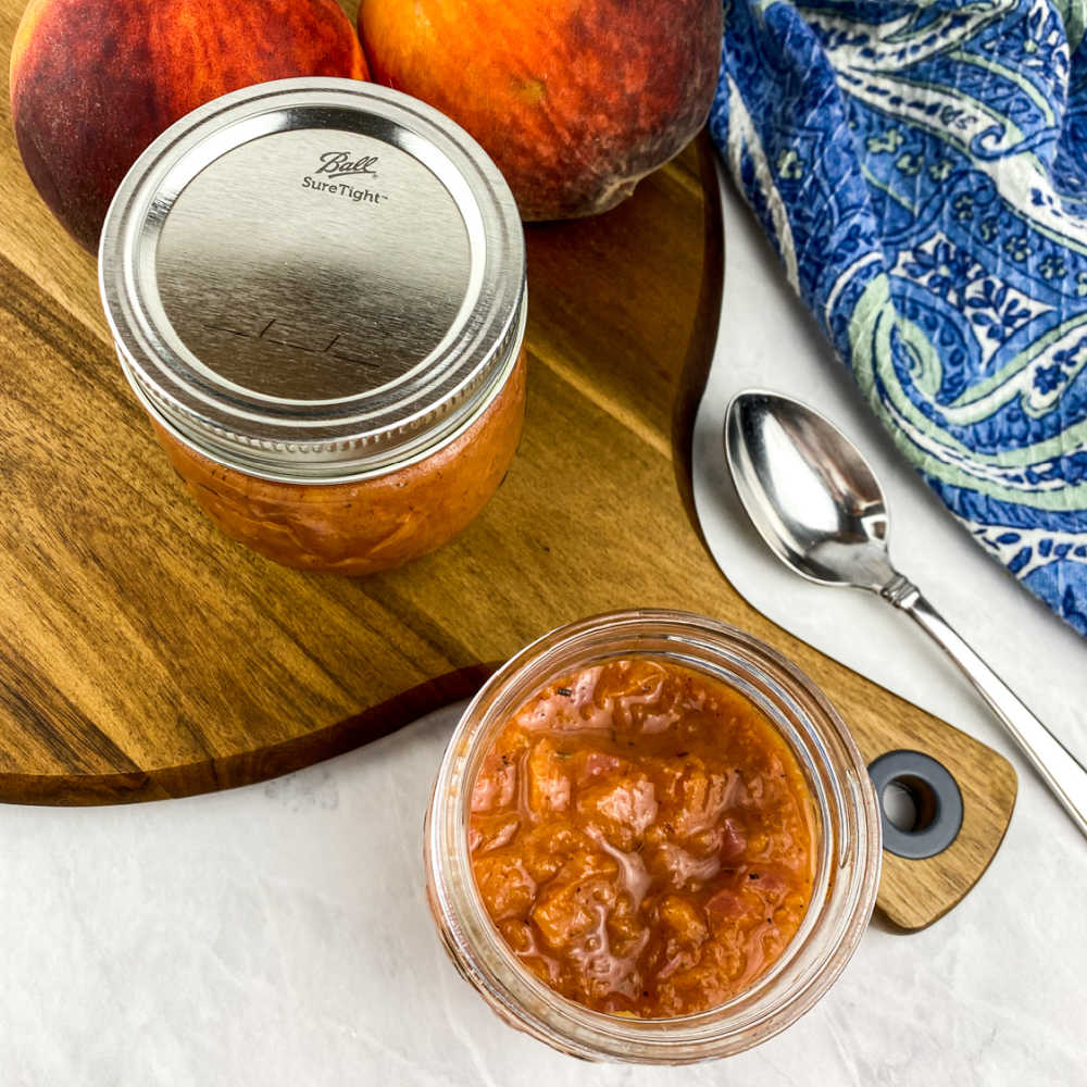 savory fresh peach compote in jars.