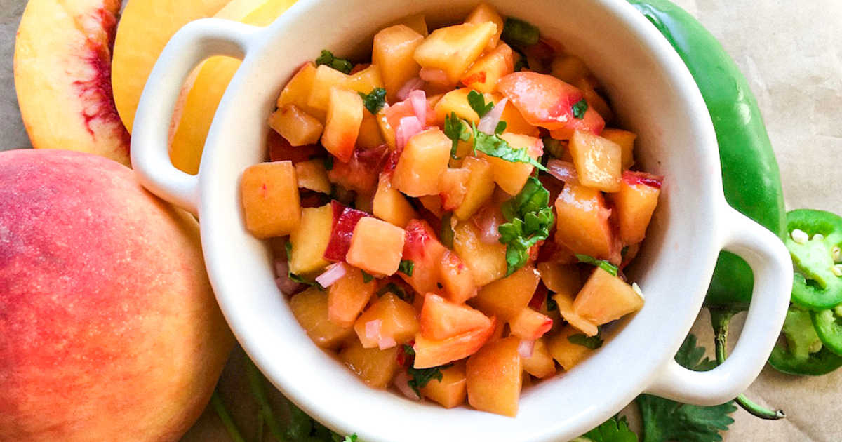 fresh jalapeno peach salsa in white bowl.