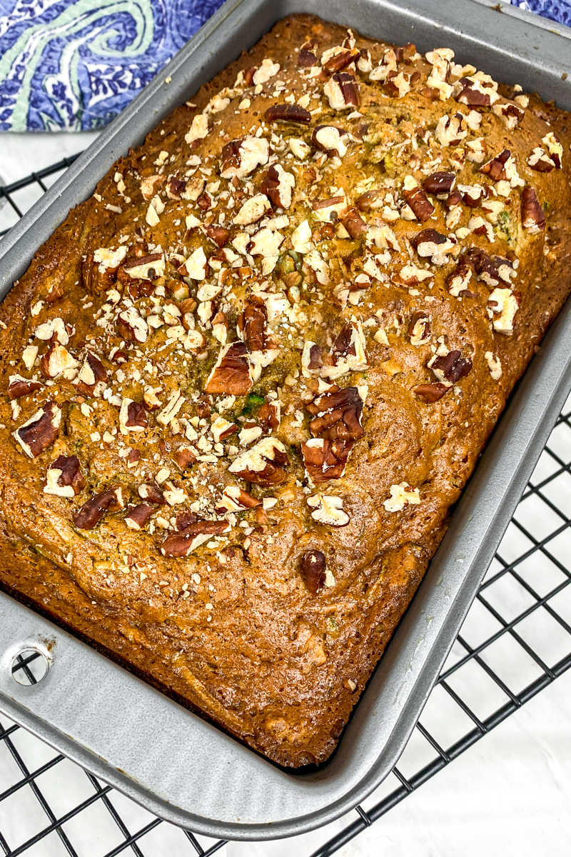 This delicious applesauce zucchini bread has pecans mixed in and on top, so you will want to bake and eat it often. 