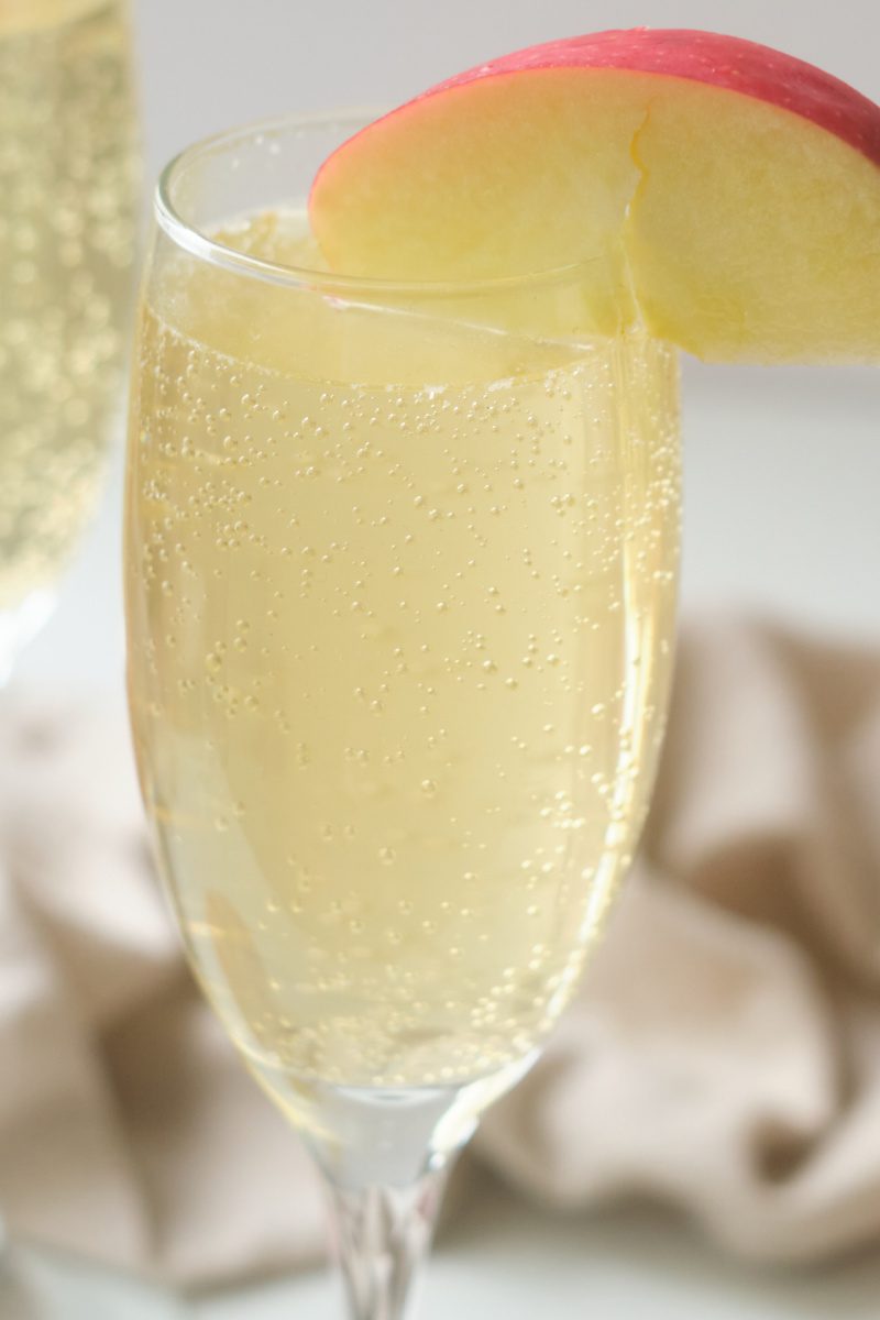Sparkling drinks are fun! Learn how to make an easy non-alcoholic sparkling caramel apple mocktail that's perfect for kids and adults. Caramel sauce, apple juice and bubbles are the stars of this party drink.