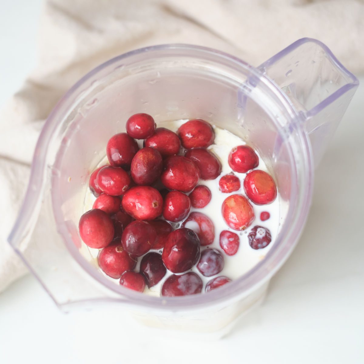 fresh cranberries and cream in blender