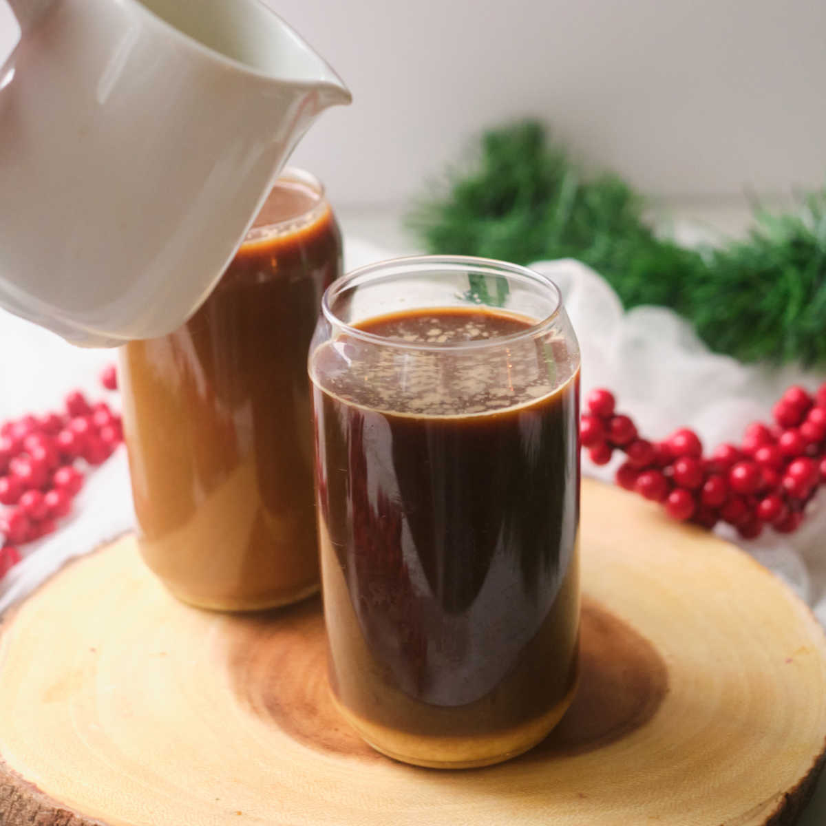 adding cream to iced coffee