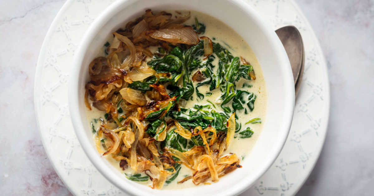 bowl of creamed spinach with caramelized onions