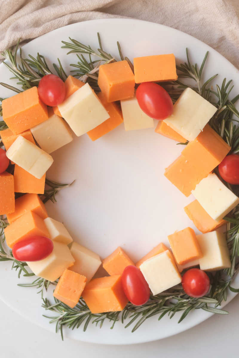 This holiday themed Christmas wreath cheese platter is easy to make and will help make your holiday table look festive. 