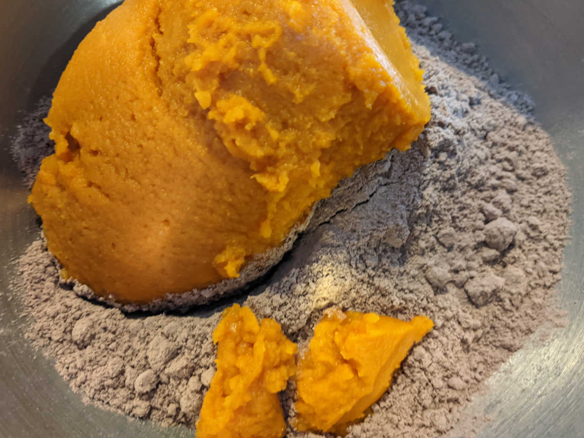 pumpkin and cake mix in mixer bowl