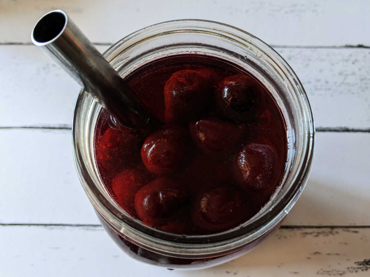 cherry hibiscus tea in mason jar with metal straw