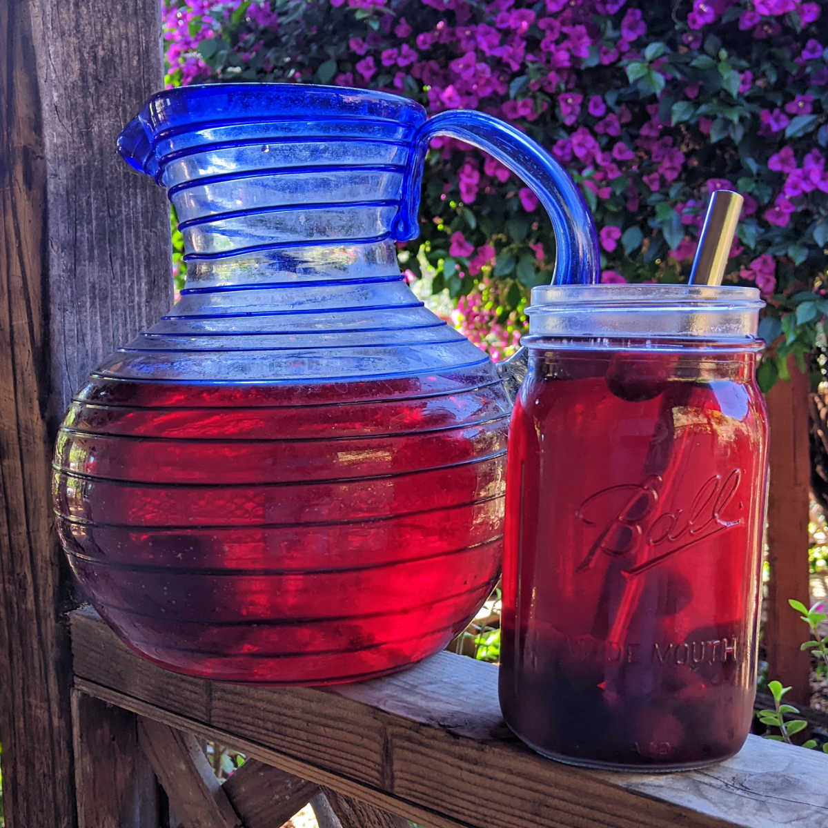 glass pitcher of cherry hibiscus sun tea