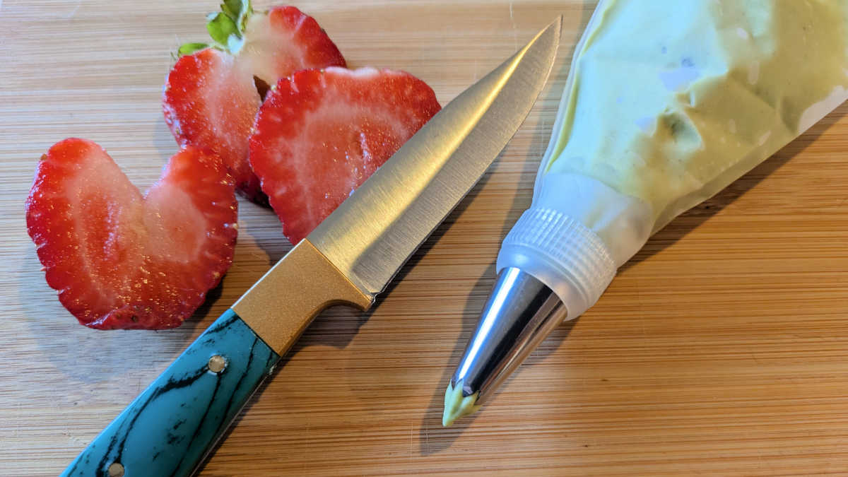 strawberries knife and guacamole in piping bag