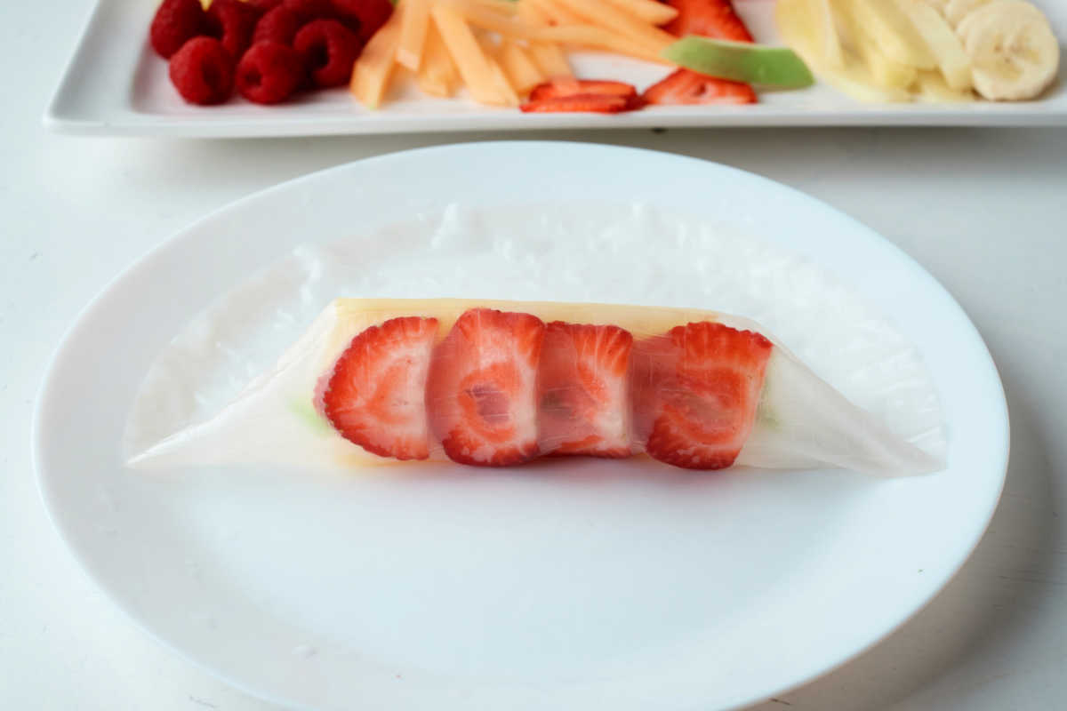 rolling a fruit spring roll