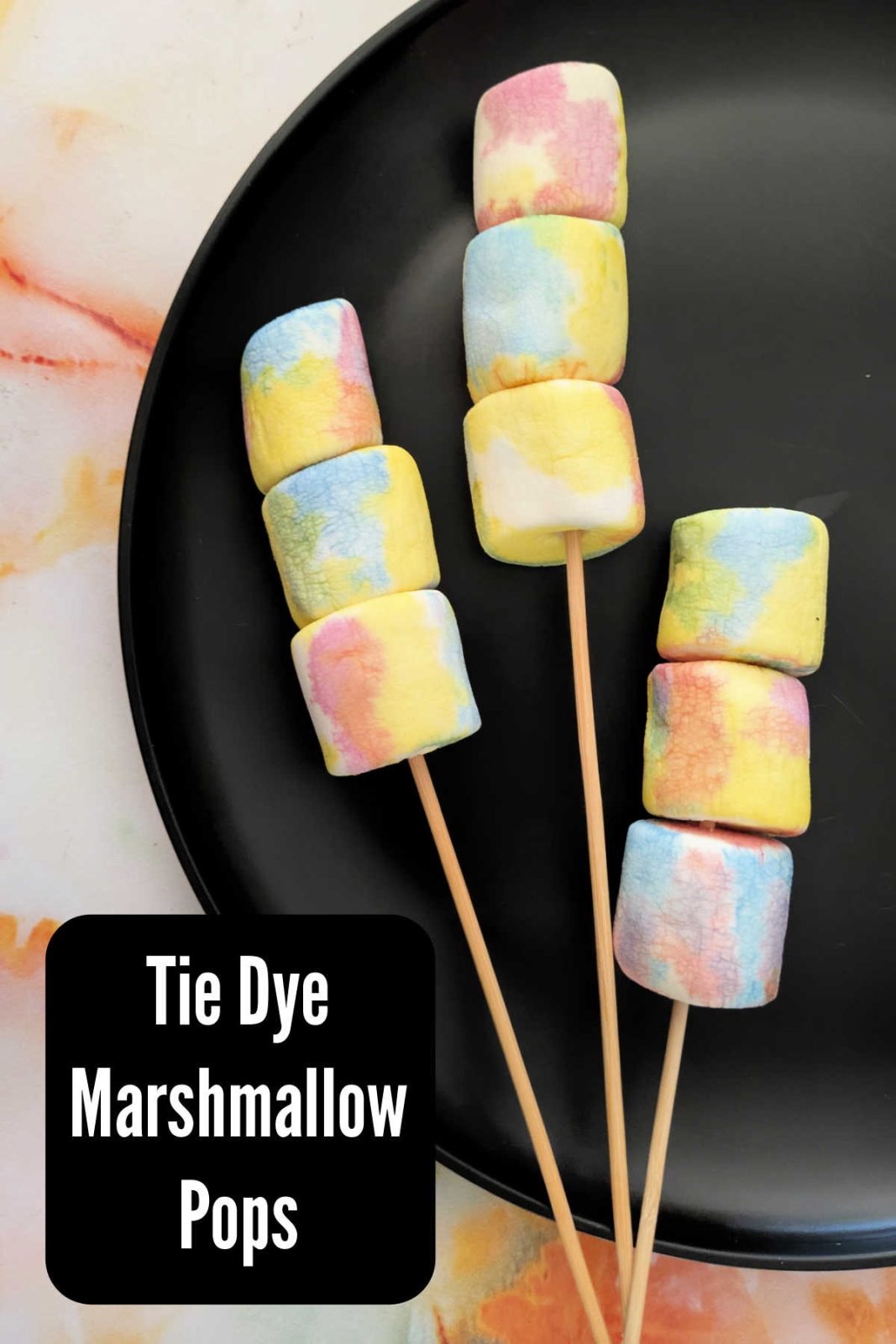Make these fun and easy Tie Dye Marshmallow Pops for a colorful treat! A simple recipe using natural food coloring is perfect for kids and parties.